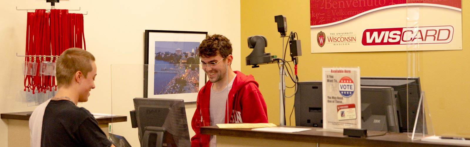 A customer receiving assistance at the Wiscard front desk.